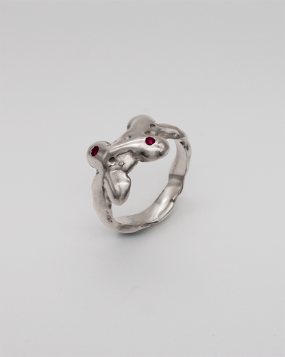 Silver ring with pink stones on a light gray background