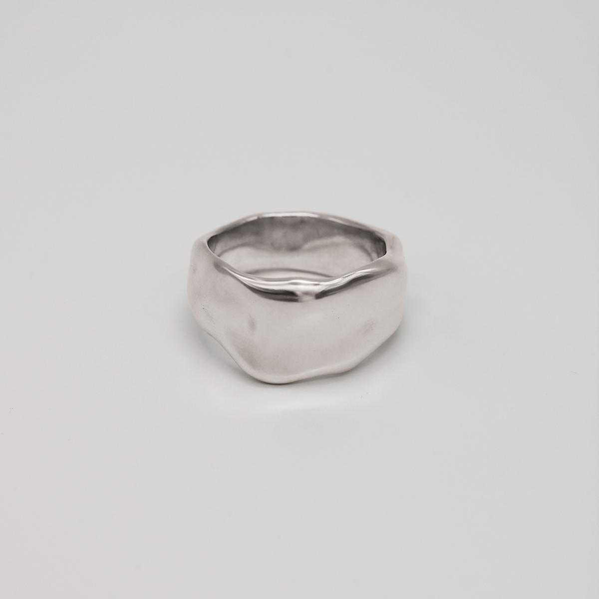 Silver ring on a light gray background