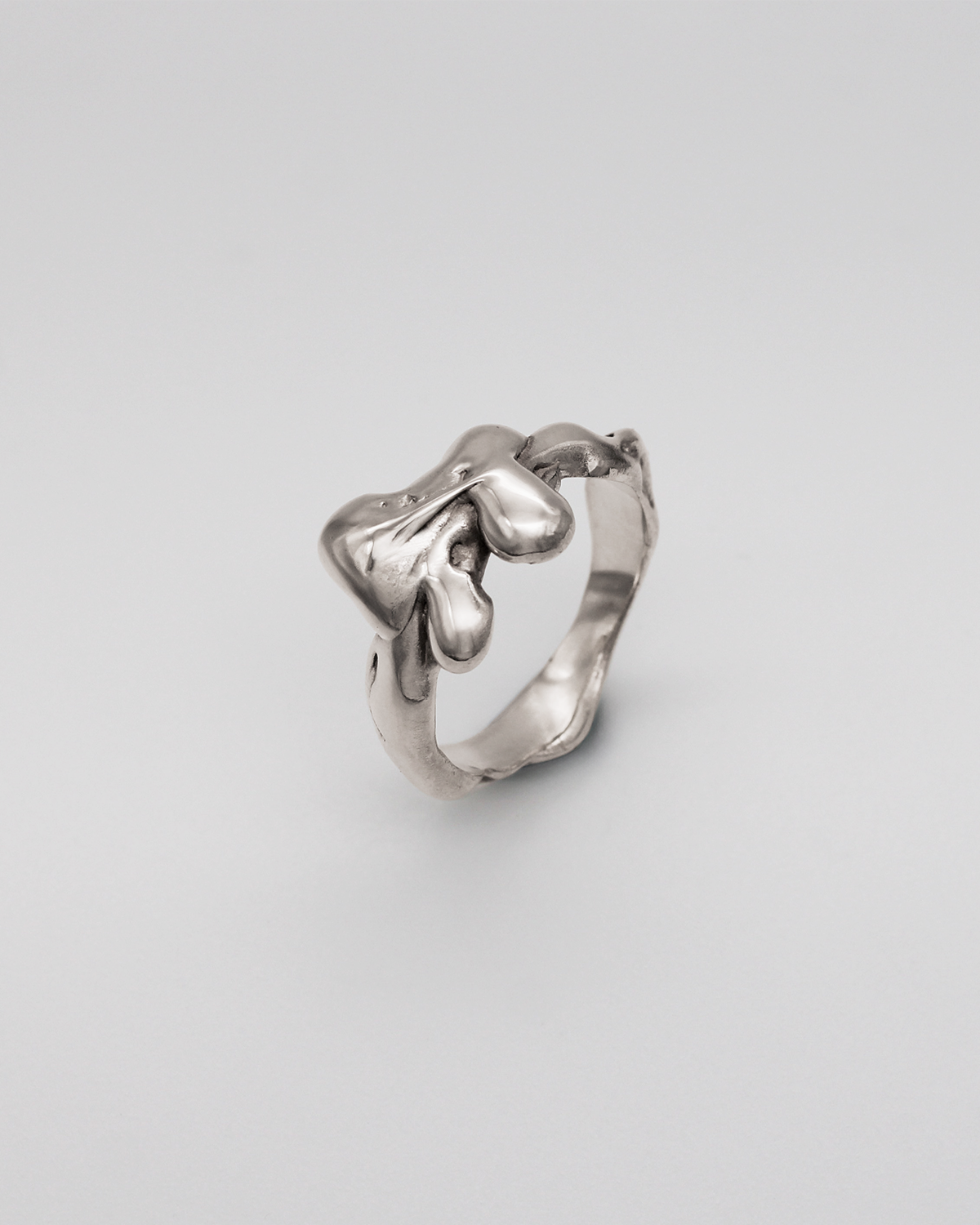 Silver ring on a light gray background