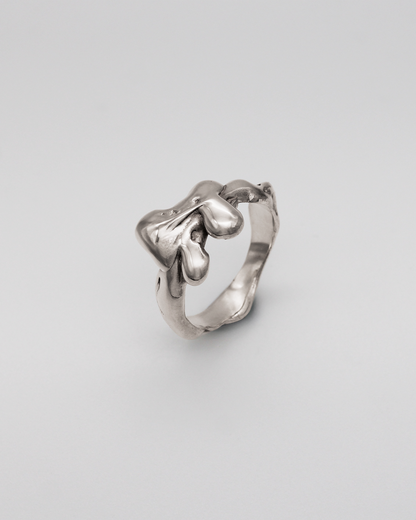 Silver ring on a light gray background