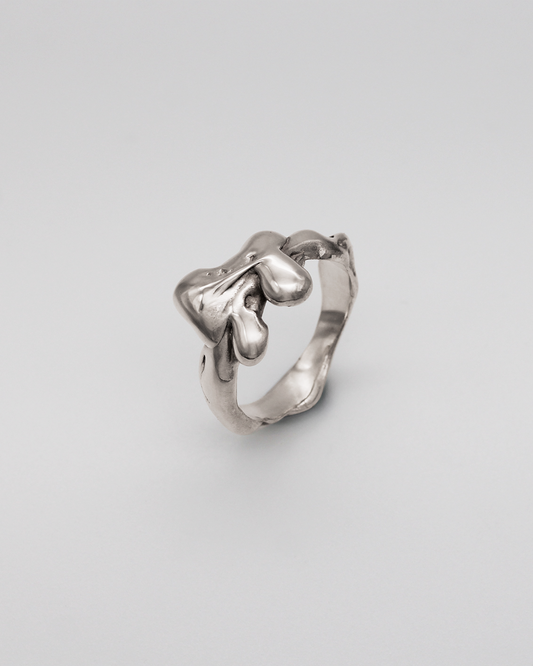 Silver ring on a light gray background