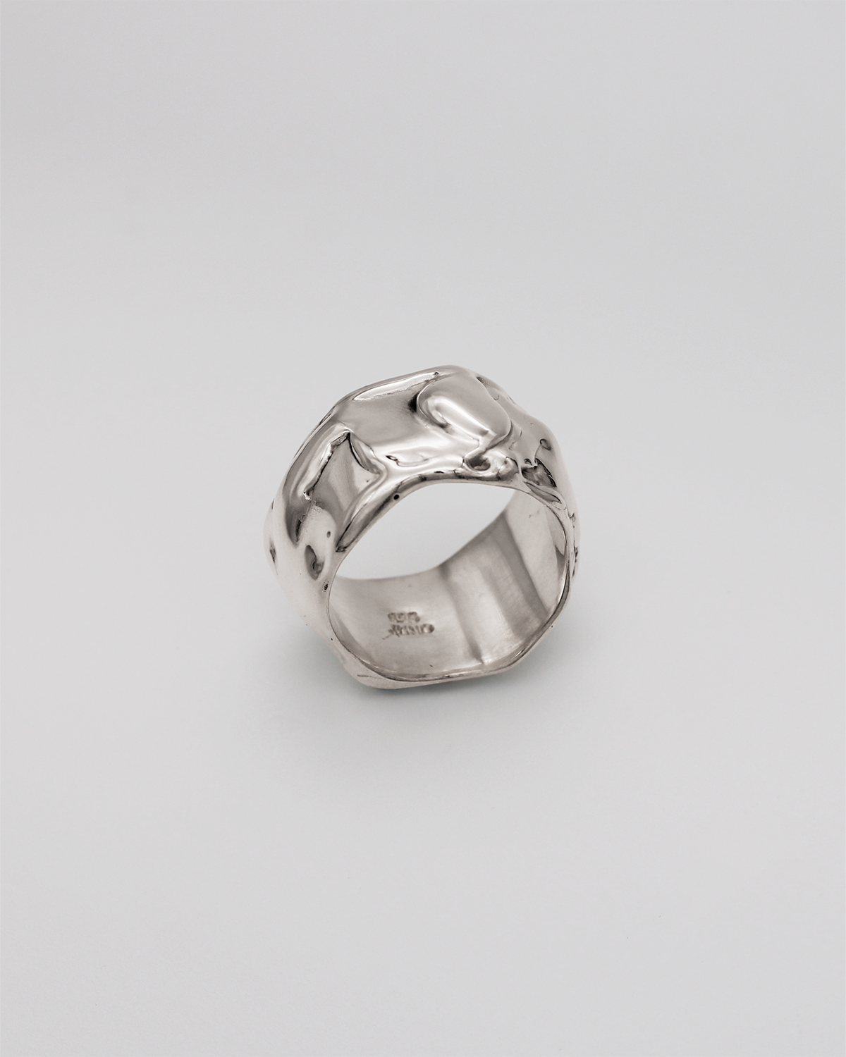 Silver ring on a light gray background