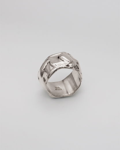 Silver ring on a light gray background