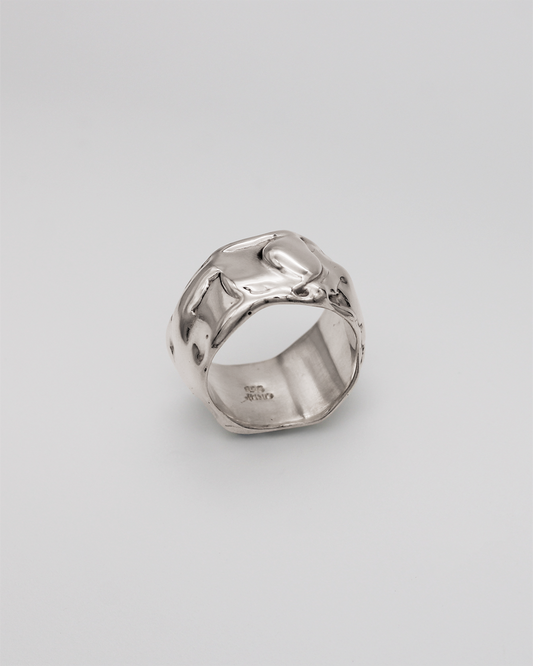 Silver ring on a light gray background