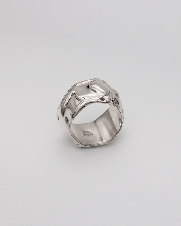 Silver ring on a light gray background