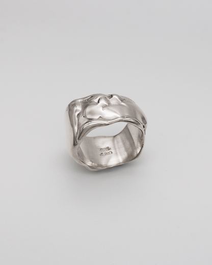 Silver ring on a light gray background