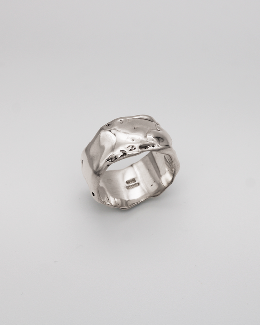 Silver ring on a light gray background
