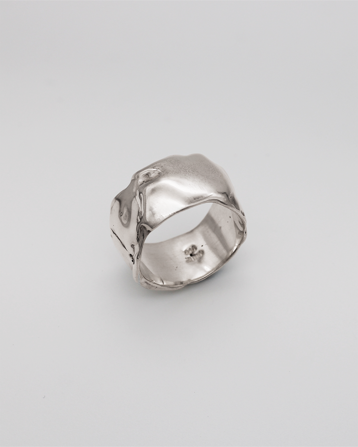 Silver ring on a light gray background