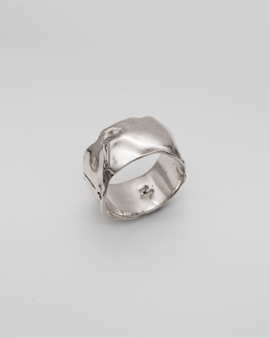 Silver ring on a light gray background
