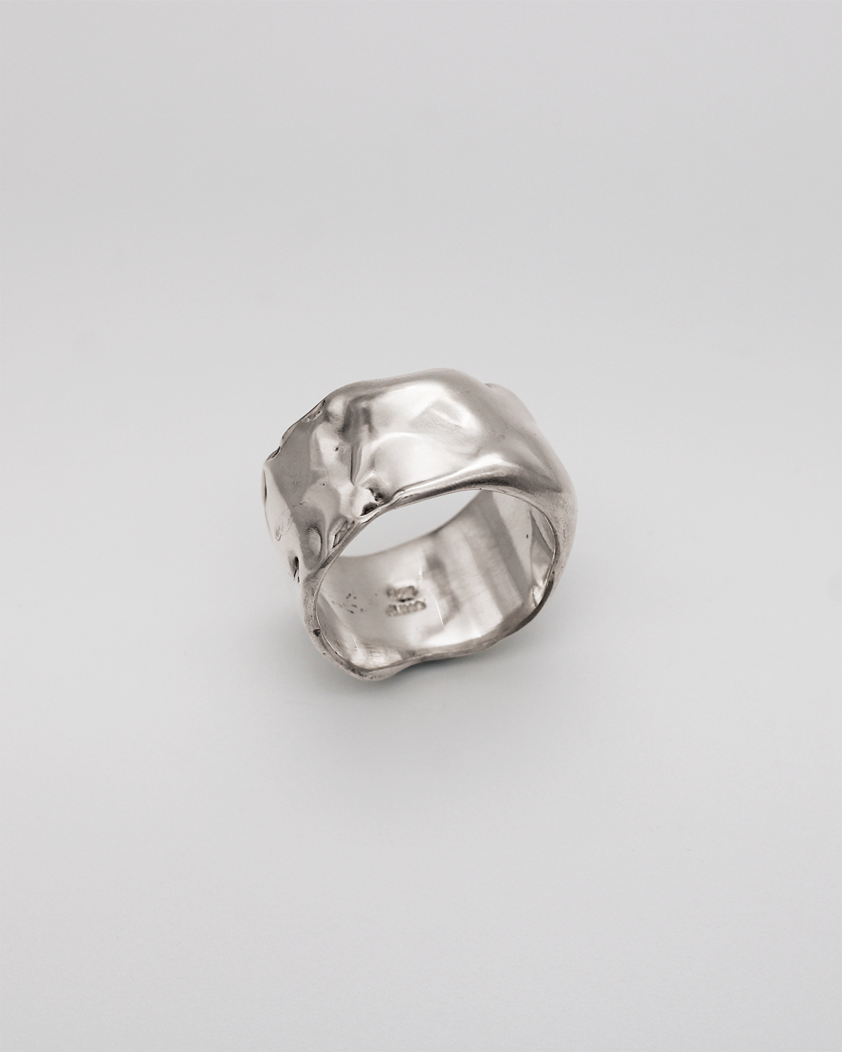Silver ring on a light gray background