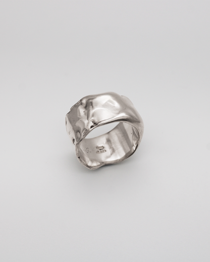 Silver ring on a light gray background