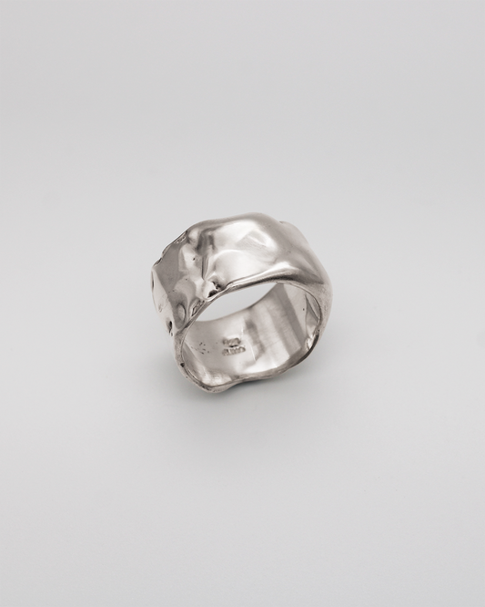 Silver ring on a light gray background