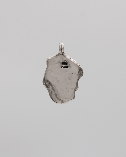 Silver pendant on a gray background