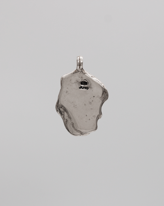 Silver pendant on a gray background