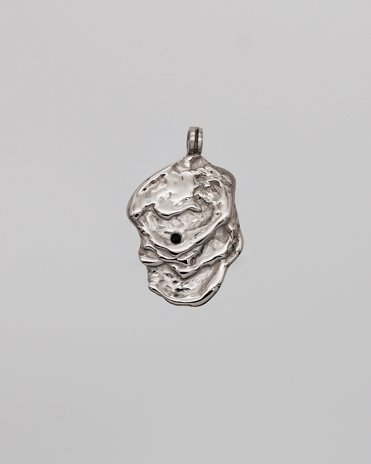 Silver pendant on a gray background
