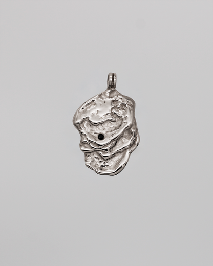 Silver pendant on a gray background