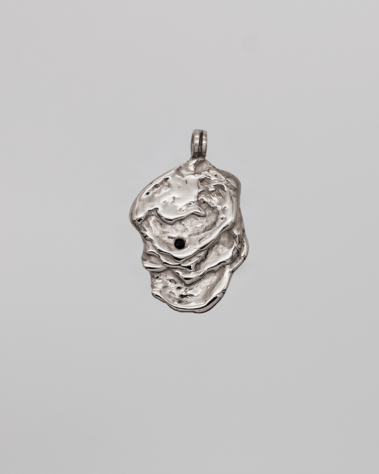 Silver pendant on a gray background