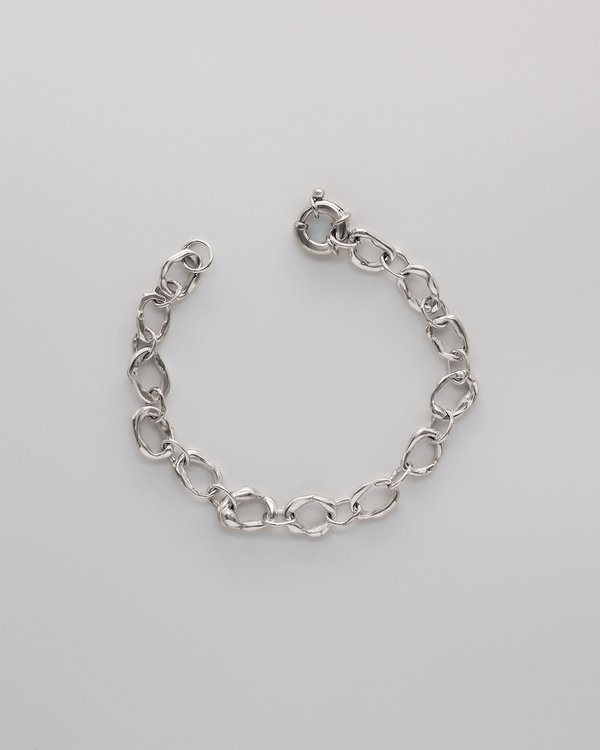 Silver chain bracelet on a light gray background