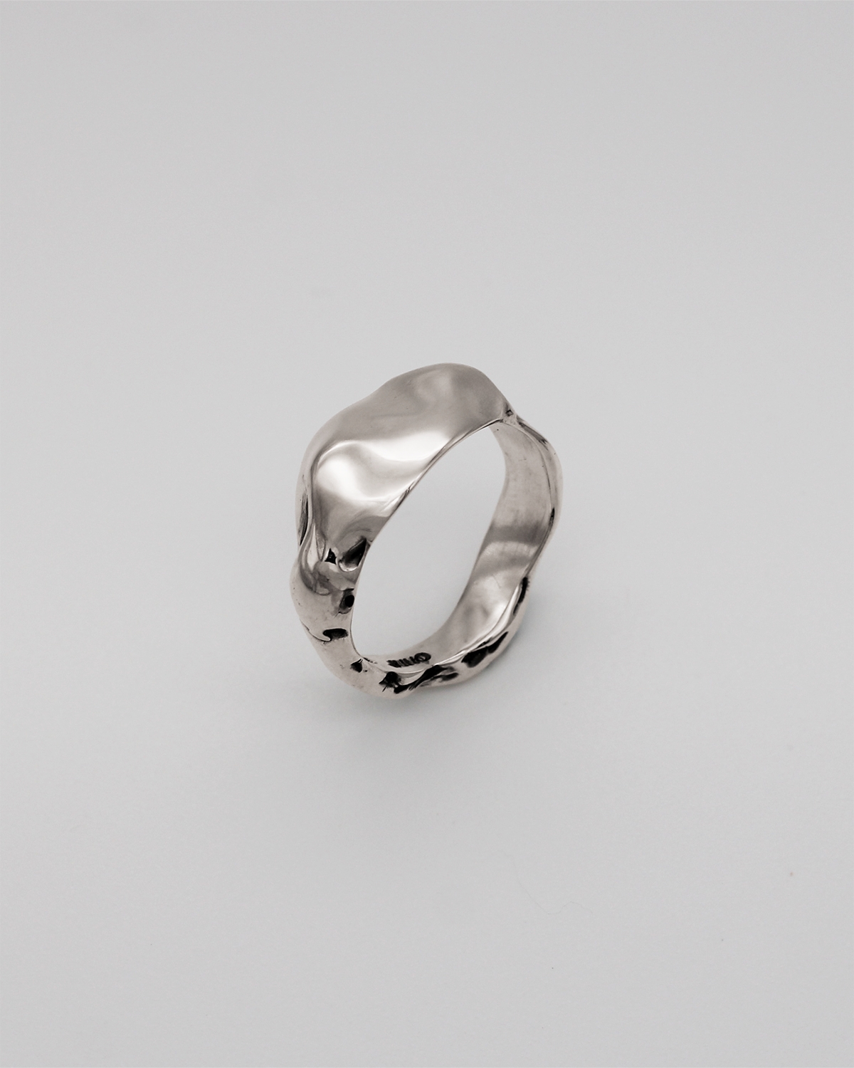 Silver ring on a light gray background