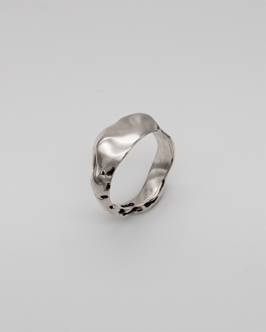 Silver ring on a light gray background